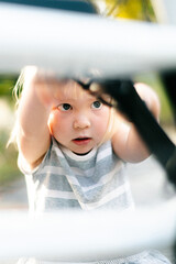 Child looks at bicycle