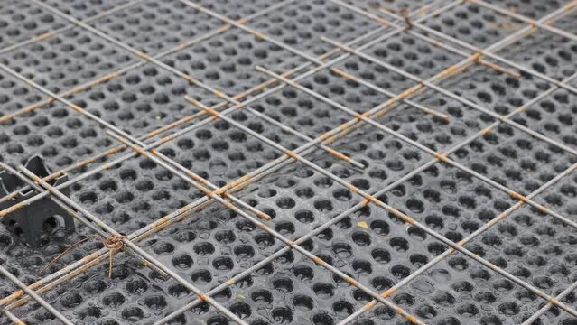 Reinforcement for reinforced concrete bonded over the membrane for waterproofing concrete. Pouring the foundation using modern waterproofing materials. Frame for the reinforced concrete stylobate