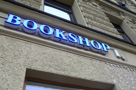 Glowing bookshop sign board on wall