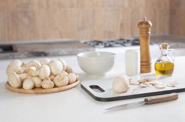 Fototapeta na wymiar raw champignons on white kitchen table