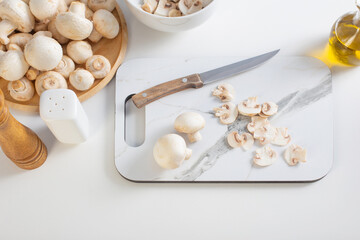 Fototapeta na wymiar raw champignons on white kitchen table