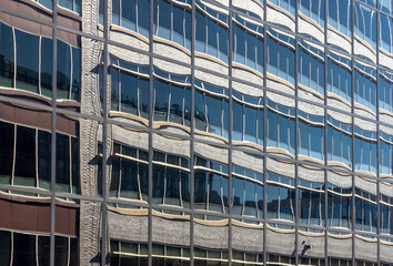 The glazed facade of an office building with reflections