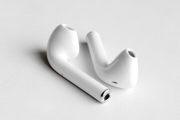 Wireless headphones on a white background, Close-up. The concept of modern technology.