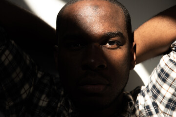 front portrait african american man staring in shadow