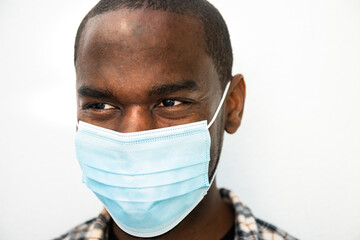 Close up african american man by white background with mask on face