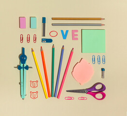 Neatly arranged made of office or school supplies. Minimal concept against beige background. Flat lay.