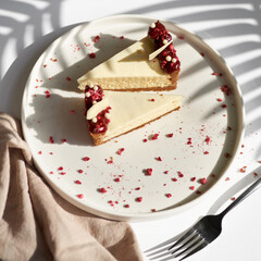 Sliced Cheesecake. Layer of biscuits, mousse based on creamcheese, with raspberry. Healthy dessert.