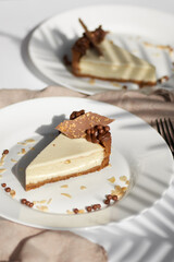 Sliced Cheesecake. Layer of biscuits, mousse based on creamcheese, with chocolate cream. Healthy dessert.