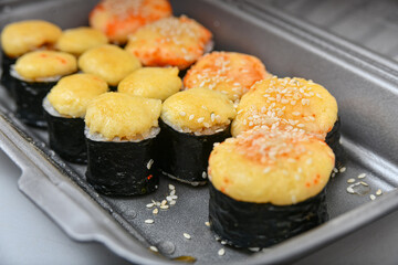 Japanese sushi food, rolls with tuna, shrimp, salmon, crab, avocado, uramaki, hosomaki and nigiri. Assorted different rolls in plastic packaging.