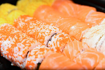 Salmon sushi, seafood sets cold and baked with cheese and sauce.