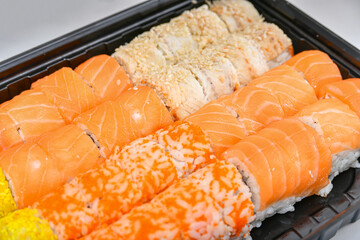 A variety of Japanese sushi sets with shrimp, cheese, crab, salmon and eel wrapped in rolls.