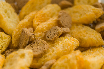 Salted rusk for beer close-up. Light snack with salt and pepper. Croutons from wheat and rye bread. Soft focus, abstract, food background