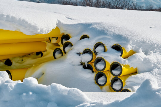 Gas pipes on a construction site under the snow.