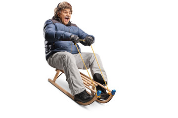 Excited mature man riding on a wooden sleigh