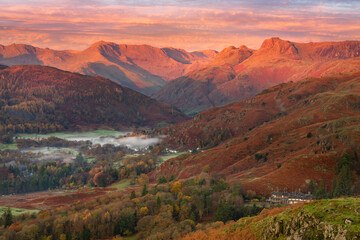 Breathtaking Winter sunrise light on the Langdale mountain range in the Lake District, UK. Taken from Loughrigg Fell on a beautiful Autumn morning. 