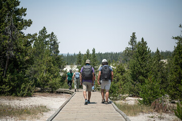 A family walking on a board walk on a National Park