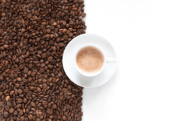 Cup of aromatic coffee and coffee roasted beans isolated on white background, top view