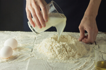 Woman kneading dough on table