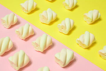 apricot and strawberry marshmallows in rows on pink and yellow background