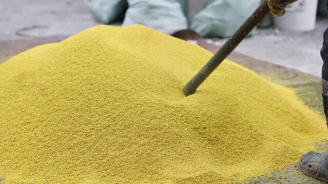 Rubber coating for playgrounds applied on the surface by a steel roller tools. PDM rubber granules. Floor covering for sports. Rubber mulch for safety and injury prevention. Selective focus.
