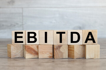EBITDA The word demand on stacked wooden cubes.