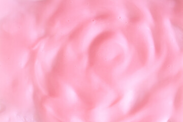 Background of pink cream texture. Berry fruit yogurt or whipped cream. Smooth surface of body lacquer cream. Slime pink.