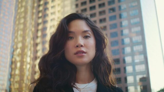 Portrait of beautiful asian model close up. Attractive woman posing on street.