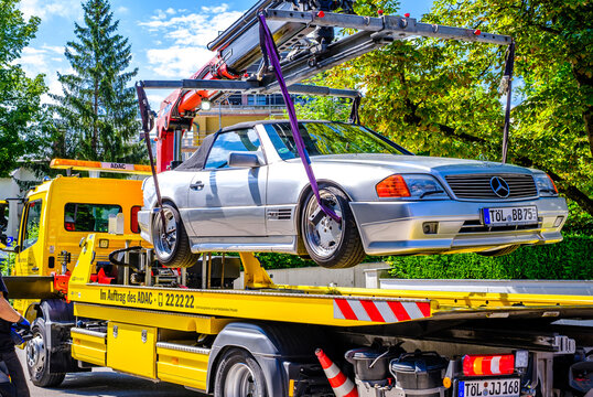 Bad Tolz, Germany - July 27: a tow truck lifting a mercedes benz at a street in bad tolz on July 27, 2021