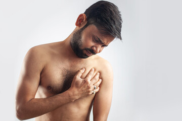 asian man clutching his chest in pain, heart attack, heart burning pain
