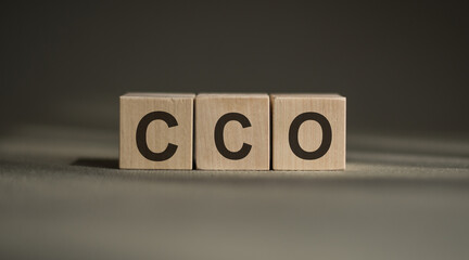 Acronym Chief Compliance Officer on wooden cubes on dark grey background. Business concept