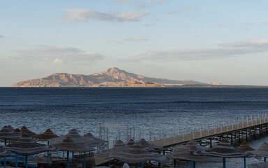 Dilapidated Pier in the Red Sea. Tiran Island on Backdrop.