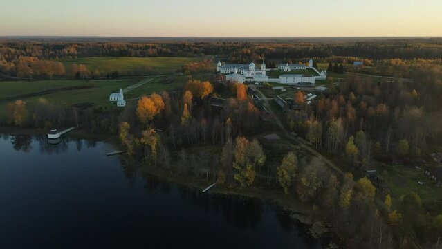 Pokrovsko-Tervenichesky monastery of the Leningrad region on the shore of the lake. Video of autumn landscape with a beautiful sunset and an Orthodox convent.