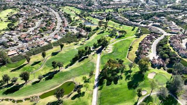 Aerial view of green golf in upscale residential neighborhood in South California. USA. 