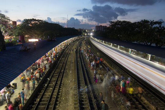 Dhaka, Bangladesh - 24 June 2017: View of many people at the local train station at sunset, Bangladesh.