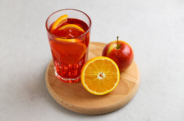 Spanish drink sangria with fruit and ice cubes on a gray background. Selective focus. 