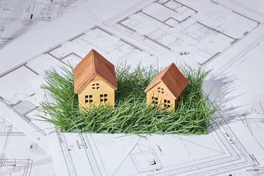 House building project concept with plans on grass