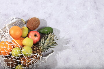 Healthy natural food in eco bag, healthy lifestyle concept, zero waste. Food delivery, donation, coronavirus quarantine. Tropical fruits and clean water in tissue pack, vegetarian diet,