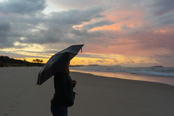 person with umbrella on the beach