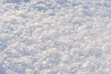 Fresh white shiny snow close up. Crystal snow macro photo. Snow background