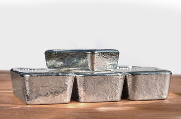 Four bullion bars of precious metal on a neutral background. Platinum, palladium, pgm, silver.