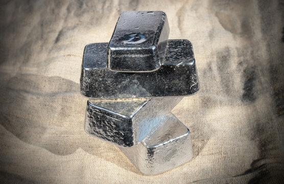 Four bullion bars of precious metal on the background of the fabric texture. Platinum, palladium, pgm, silver.