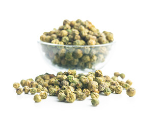 Dried green peppercorn. Dry green pepper spice in bowl isolated on white table.