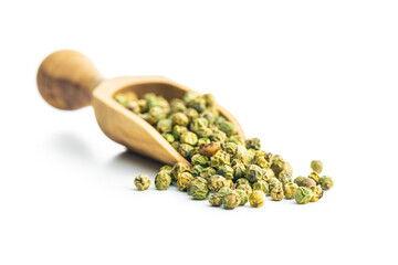 Dried green peppercorn. Dry green pepper spice in scoop isolated on white table.
