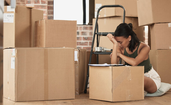 To some moving house is just another habit. Shot of a young woman having a stressful day during packing at home.