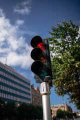 A vertical shot of traffic lights on a sunny day