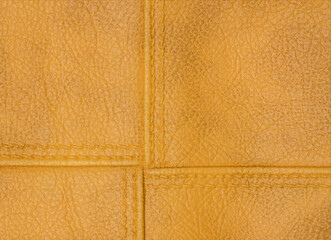 Fototapeta premium Yellow texture leather background. Stitch leather.