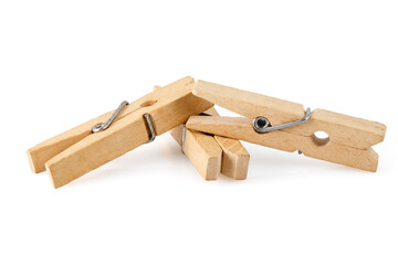 Three wooden clothespins, isolated on a white background, lie together. Close-up photo. Full depth of field.