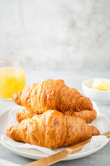 Breakfast with croissants and orange juice.