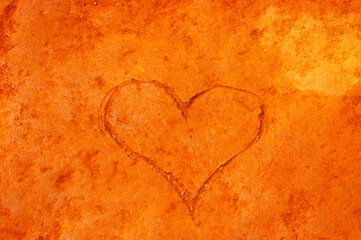 Heart carved on cliff Rustrel ocher canyon. Provencal Colorado near in Southern France. Happy orange Valentine's day background