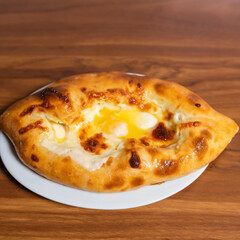 Adjarian khachapuri on a wooden board. Traditional Georgian cuisine